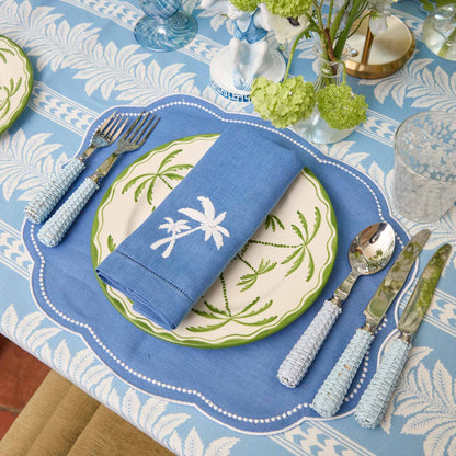 Sets de table et serviettes palmiers en lin bleu Eloise (lot de 4)